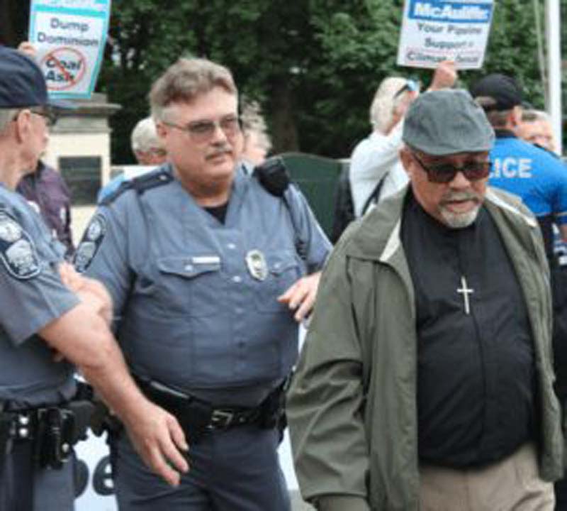 Pastor arrested at protest.