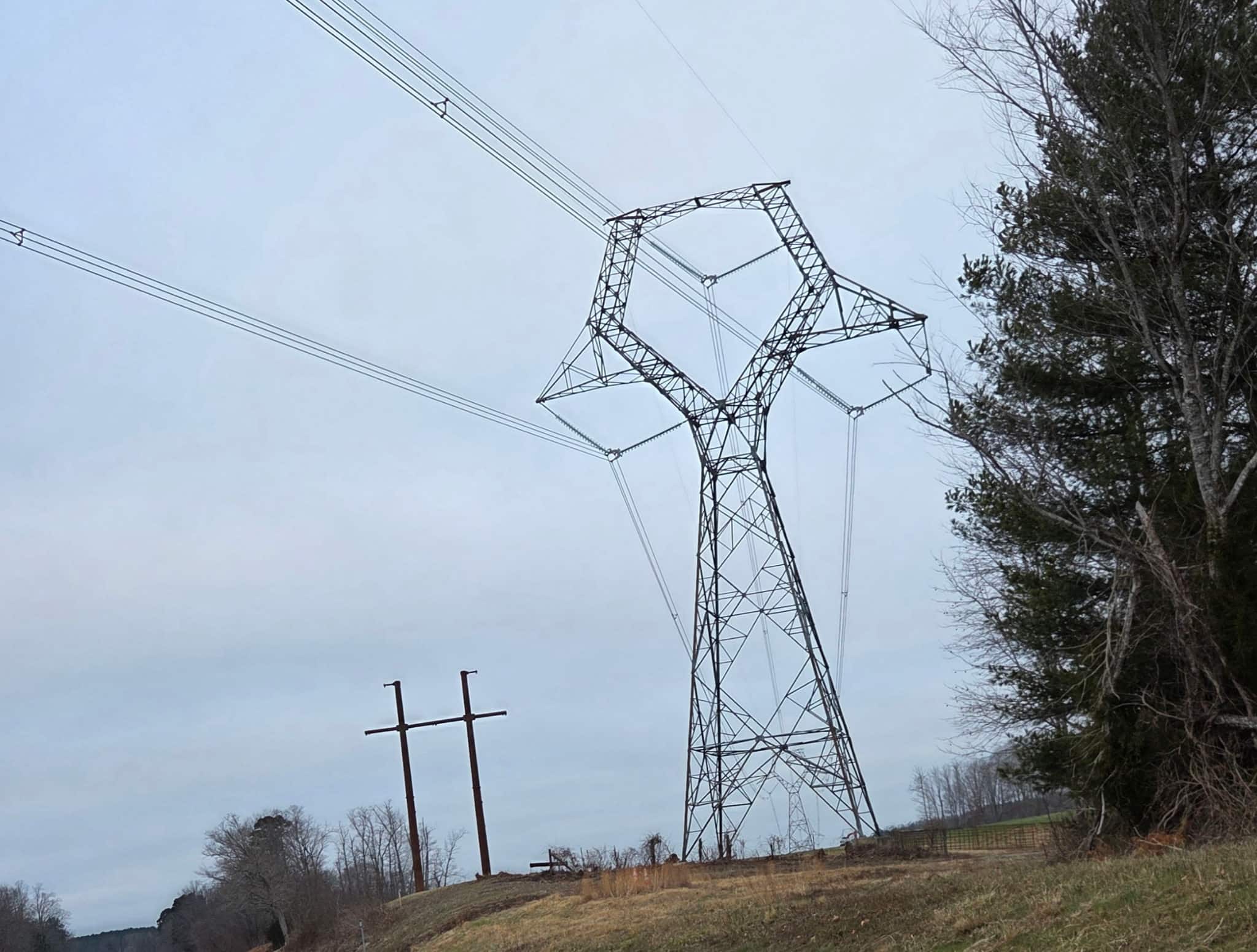 Transmission line towers above rural landscape